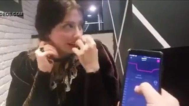 cute girl with remote vibrator in public